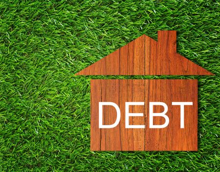 Debt concept, financial crisis, money problem, home loan on green grass background 