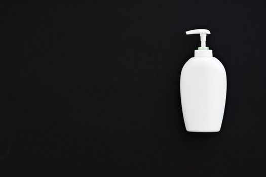 Blank label cosmetic container bottle as product mockup on black background, hygiene and healthcare