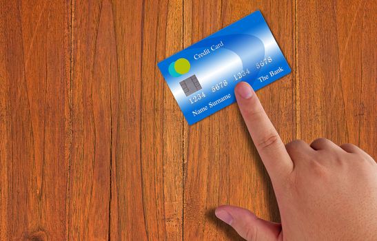 Hand holding credit card on wood table background, online payment, electronic commerce financial concept  
