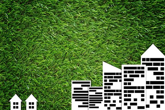 Different concept, group of building on green grass background