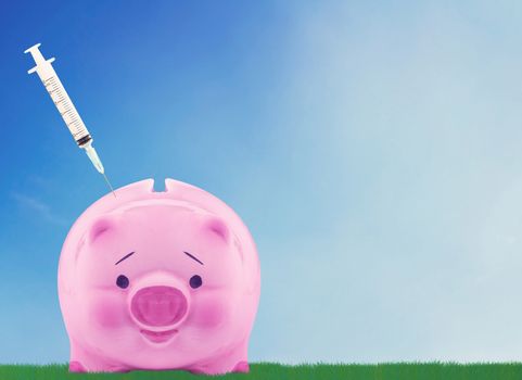 Financial planning concept, money solution,  piggy bank and syringe on blue sky background