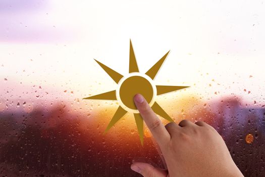 Good morning and wake up concept, hand holding sun paper cut on glass background, rain and water drop