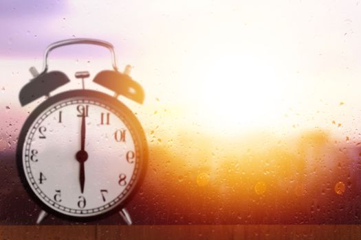 Good morning and wake up concept, alarm clock reflection on glass 