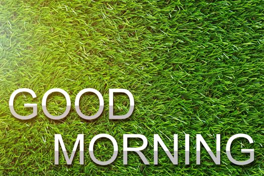 Good morning and wake up concept, greeting paper cut text on green grass background