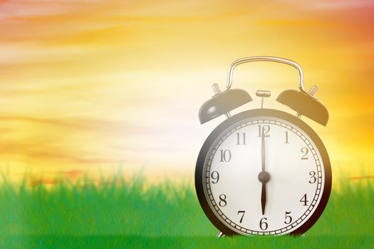 Good morning and wake up concept, alarm clock on green grass