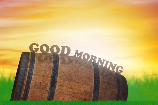 Good morning and wake up concept, wood barrel on green grass