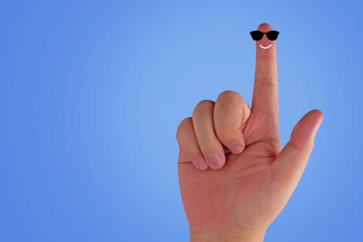 Happiness concept, finger smile and sun glasses on blue background