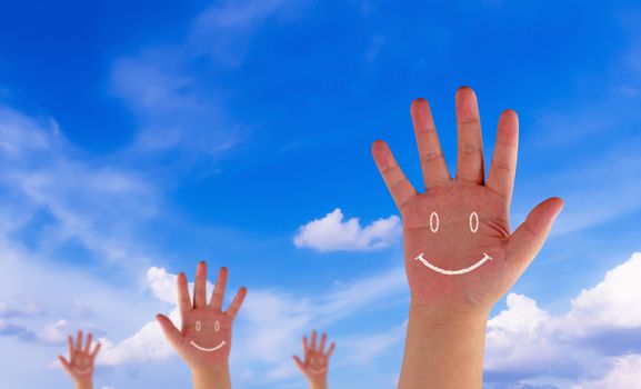 Happiness concept, hand and drawing smile on blue sky background