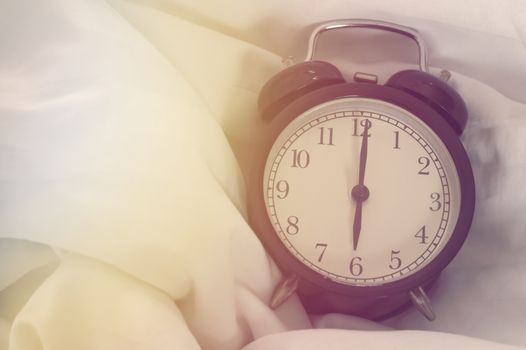 Good morning and wake up concept, alarm clock on the bed, time to work
