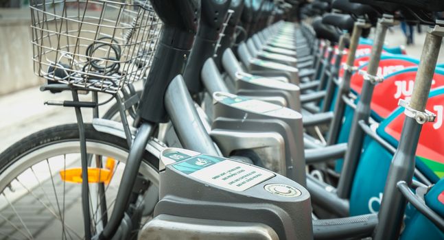 Dublin, Ireland - February 12, 2019: Detail of a shared public bike station Just Eat dublinbikes in the city center on a winter day