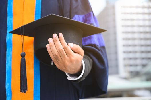 Close up Graduation holding graduation cap education concept