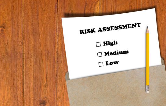 Risk assessment, business planning concept, white paper and yellow pencil on brown envelope