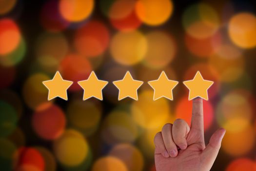 Rating and evaluation concept.  hand and five yellow star on blur background