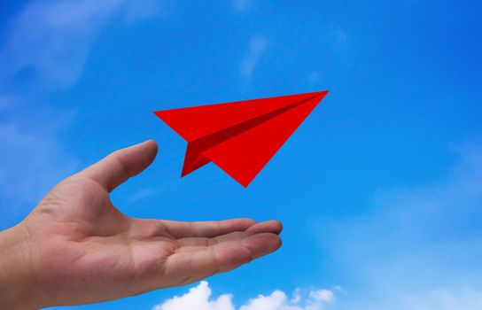 Business start concept, strategy and planning, road to success, hand and red airplane paper on blue sky background