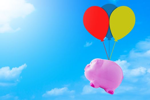 Financial, saving money concept, pink piggy bank on blue sky background