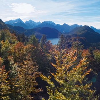 Beautiful nature of European Alps, landscape view of alpine mountains, lake and village on a sunny day, travel and destination scenery