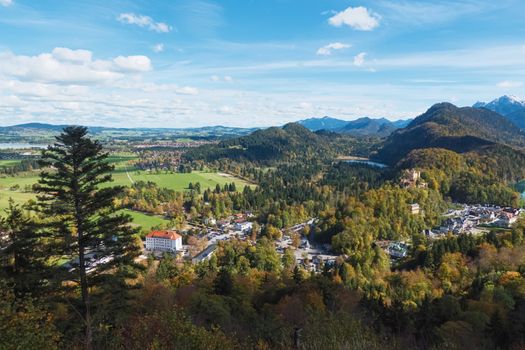 Beautiful nature of European Alps, landscape view of alpine mountains, lake and village on a sunny day, travel and destination scenery