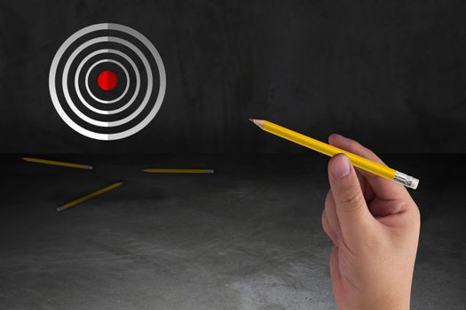 Business target concept, marketing strategy and planning, hand holding yellow pencil aim to goal 