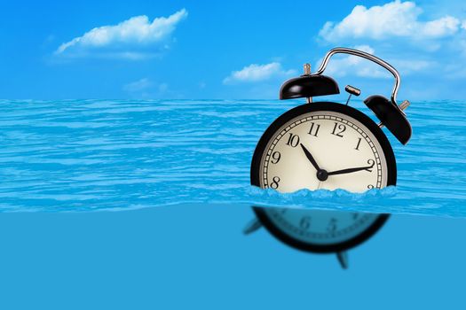 Waste of time concept, alarm clock on the water