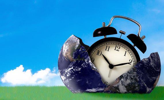 Time management concept, business planning, The Earth and retro clock on green grass , Elements of this Image Furnished by NASA