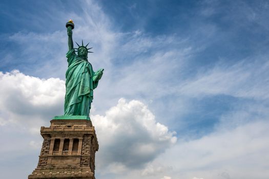 Statue of Liberty on Liberty Island closeup with blue sky in New York City Manhattan - Image