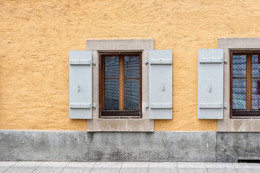 Windows with shutters on the wall of an old building in Geneva, Switzerland - image