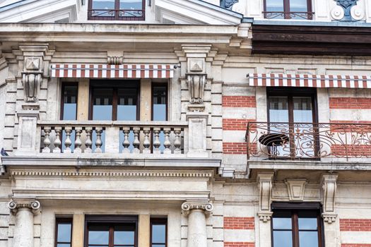 Facade of a historic brick building with metal balconies. Geneva, Switzerland - image