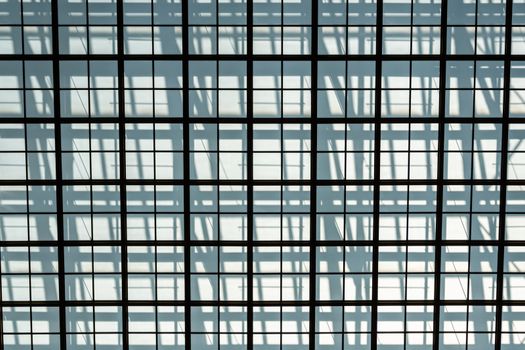 metal grille against a gray wall, the shadow of the grille - image