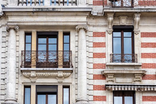 Facade of a historic brick building with metal balconies. Geneva, Switzerland - image