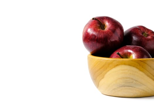 Group of red Apple above wooden bowl / basket isolated on white background