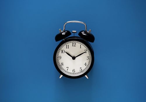 Time management concept, business planning, alarm clock on blue vintage and retro background