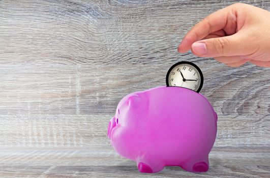 Save time concept, business management and planning, hand holding alarm clock and piggy bank