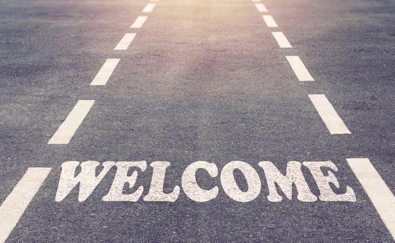 Welcome banner with text concept on road background, vintage and retro tone