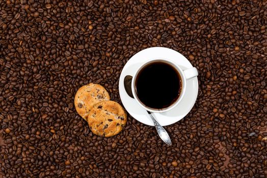 White coffee mug and cookies on the coffee beans background, top view - image