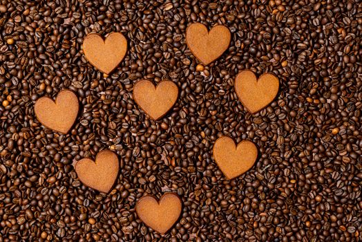 Heart-shaped gingerbread cookies on the coffee beans background - image