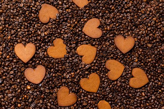 Heart-shaped gingerbread cookies on the coffee beans background - image