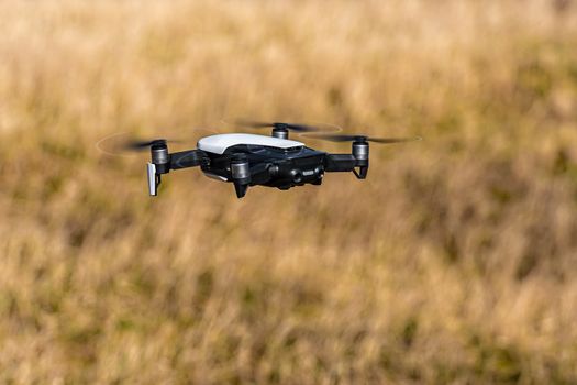 Close-up view of drone flying over agricultural field in spring, technology innovation in agricultural industry