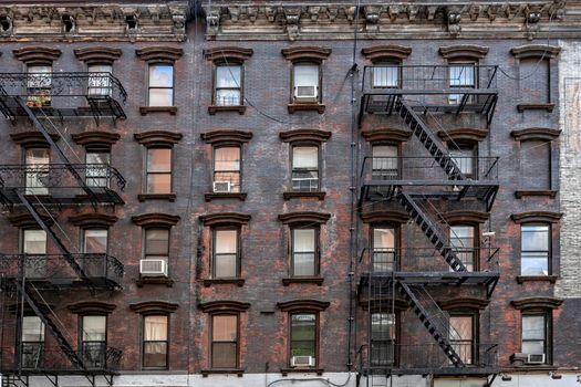 bricks buildings facades with fire escape stairs