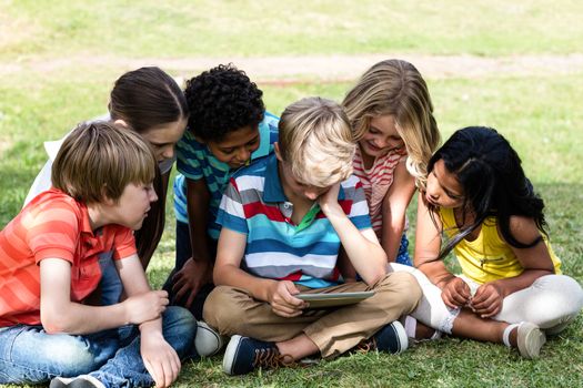 Children using digital tablet in the park