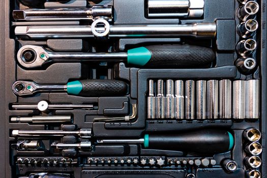 Box with special tools in car repair shop, closeup - image