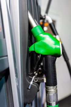 Colorful Petrol pump filling nozzles , Gas station in a service in daytime - image