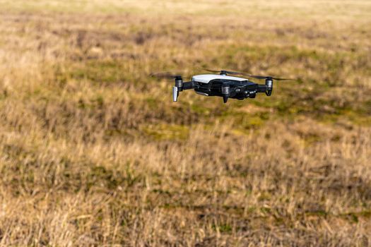 Close-up view of drone flying over agricultural field in spring, technology innovation in agricultural industry