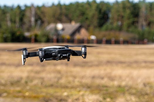 Close-up view of drone flying over agricultural field in spring, technology innovation in agricultural industry
