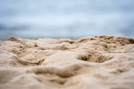 close-up of white sand on the ocean coast, summer vacation concept with space for text
