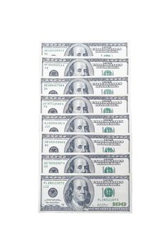 US dollar bills folded into a column with a portrait of American President Benjamin Franklin on an isolated white background