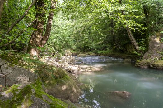 black river that comes from the marmore waterfalls in the middle of nature