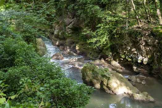 black river that comes from the marmore waterfalls in the middle of nature