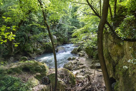 black river that comes from the marmore waterfalls in the middle of nature