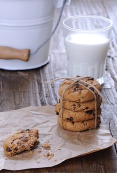 Homemade cookies with glass of milk on wooden table.