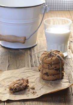 Homemade cookies with glass of milk on wooden table.